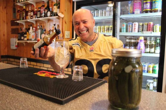 Ben Holodryga mixes a Caesar cocktail behind the bar at Elsie’s Hotel in Tolstoi. (Jordan Ross / The Carillon)