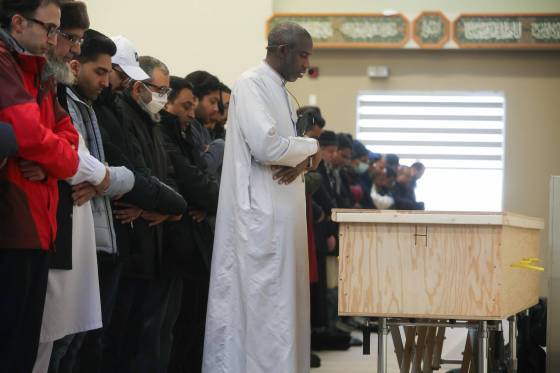 Imam Yacine Mamadou led about 100 people in prayer over Musharraf’s wooden casket, telling the mourners to do good deeds. (Ruth Bonneville / Winnipeg Free Press)