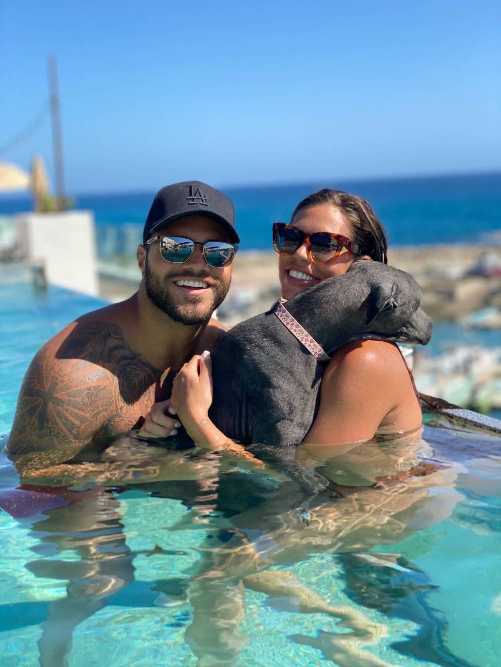 Supplied
Bombers running back Brady Oliveira and Alex Blumberg take a dip with one of their four-legged amigos.