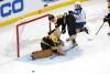 Boston goaltender Jeremy Swayman watches the puck after making a save as Jake DeBrusk crashes into the goal next to Jets’ center Cole Perfetti during the third period. (Mary Schwalm / The Associated Press)