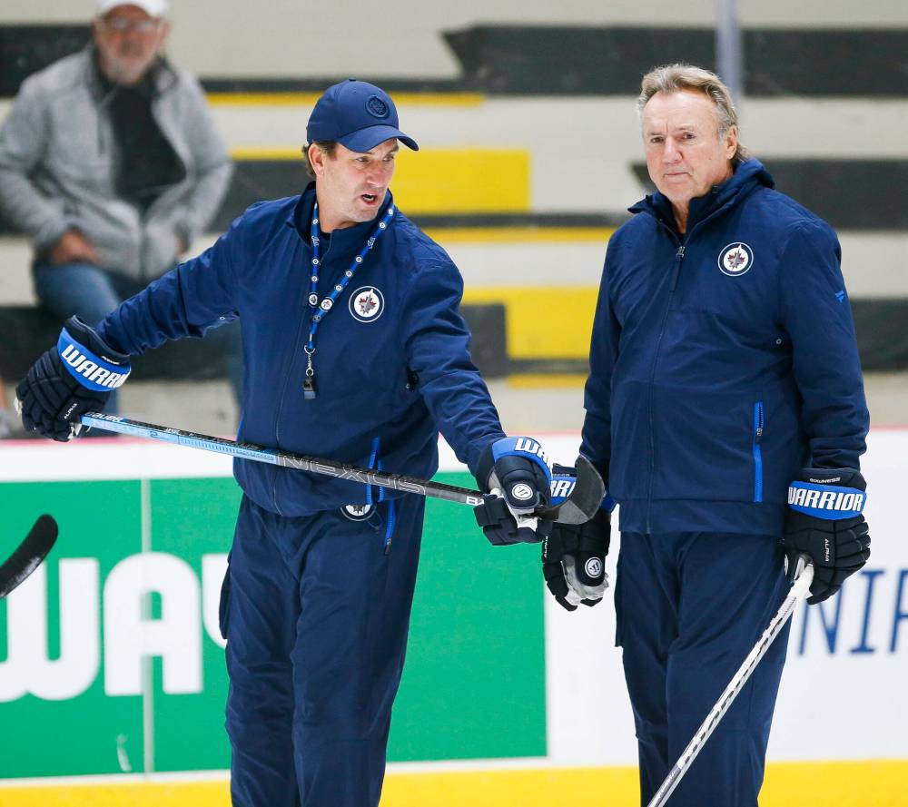 John Woods / THE CANADIAN PRESS files
Winnipeg Jets associate coach Scott Arniel (left) talks to head coach Rick Bowness during training camp in September.