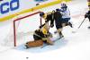 Jake DeBrusk crashes into the goal next to Cole Perfetti during the third period last Thursday. Perfetti was later sidelined after taking a hit from DeBrusk. (Mary Schwalm / The Associated Press files)