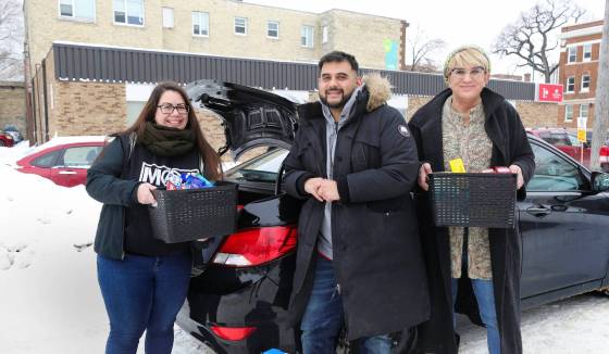 Sarah Ruff (left) and Lara Rae (right) help organize and deliver items with Omar Kinnarath, founder of the volunteer-run online group called Mutual Aid Society (MAS). (Ruth Bonneville / Winnipeg Free Press)