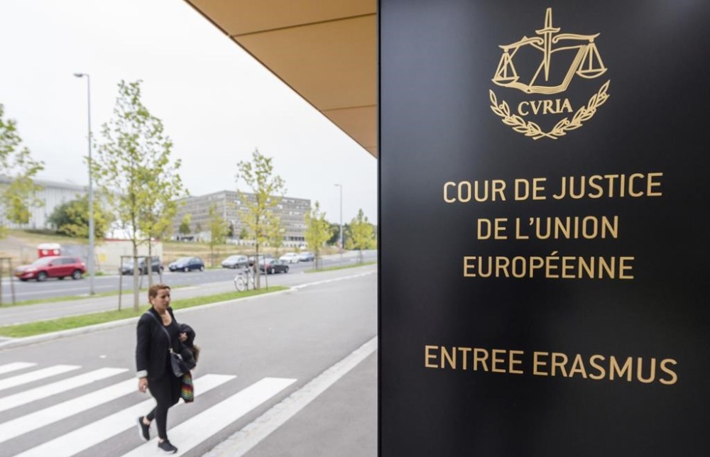FILE - In this photo taken on Oct. 5, 2015 a woman walks by the entrance to the European Court of Justice in Luxembourg. The European Union’s top court says Google has to delete search results about people in Europe if they can prove that the information is clearly wrong. People in Europe have the right to ask search engines to delete links to outdated or embarrassing information about themselves, even if it is true, under a principle known as “right to be forgotten.” (AP Photo/Geert Vanden Wijngaert)