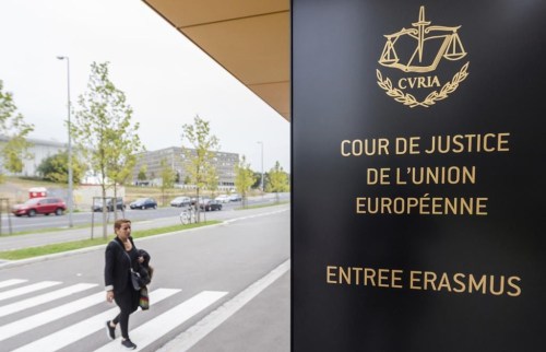 FILE - In this photo taken on Oct. 5, 2015 a woman walks by the entrance to the European Court of Justice in Luxembourg. The European Union’s top court says Google has to delete search results about people in Europe if they can prove that the information is clearly wrong. People in Europe have the right to ask search engines to delete links to outdated or embarrassing information about themselves, even if it is true, under a principle known as “right to be forgotten.” (AP Photo/Geert Vanden Wijngaert)