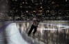 A referee skates as fans use the flashlights on their mobile devices before the third period of an NHL hockey game between the Colorado Avalanche and the Calgary Flames, in Denver, Saturday, March 5, 2022. A program aimed at reducing verbal harassment against young hockey referees is being embraced by some Nova Scotia hockey associations. THE CANADIAN PRESS/AP-David Zalubowski