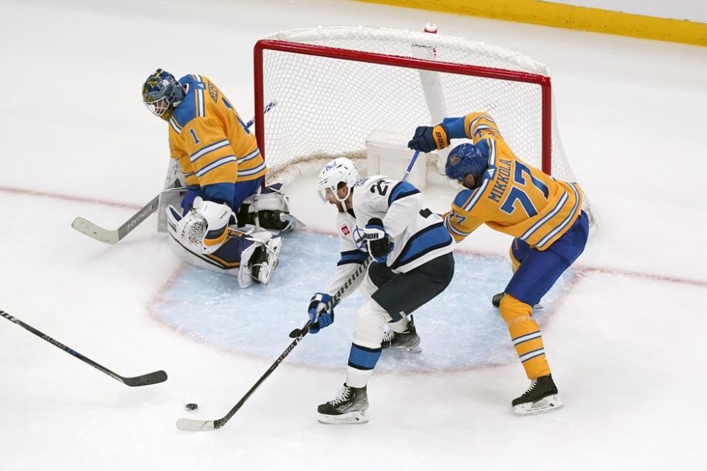 Winnipeg Jets' Blake Wheeler, center, scores past St. Louis Blues goaltender Thomas Greiss (1) and Niko Mikkola (77) during the second period of an NHL hockey game Thursday, Dec. 8, 2022, in St. Louis. (AP Photo/Jeff Roberson)