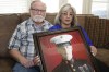 FILE - Joey and Paula Reed pose for a photo with a portrait of their son, Marine veteran and Russian prisoner Trevor Reed, at their home in Fort Worth, Texas, Feb. 15, 2022. Negotiations between the U.S. and Russia led to basketball star Brittney Griner's return to the U.S. on Friday, Dec. 9, 2022, in exchange for notorious arms dealer Viktor Bout. It is the latest in a series of high-profile prisoner swaps involving Americans detained abroad, one of whom was Reed, an American imprisoned in Russia for nearly three years. He was swapped for Konstantin Yaroshenko, a Russian pilot who had been serving a 20-year federal sentence for conspiring to smuggle cocaine into the U.S. (AP Photo/LM Otero, File)