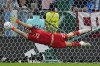 Argentina's goalkeeper Emiliano Martinez saves a kick of Virgil van Dijk of the Netherlands during penalty shootout during the World Cup quarterfinal soccer match between the Netherlands and Argentina, at the Lusail Stadium in Lusail, Qatar, Saturday, Dec. 10, 2022. (AP Photo/Natacha Pisarenko)