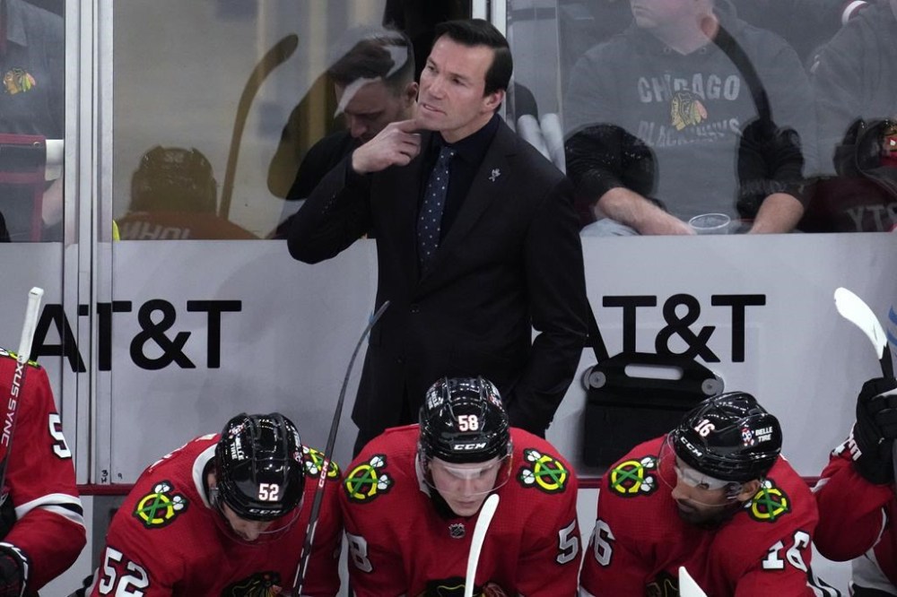 Chicago Blackhawks coach Luke Richardson, top, watches play during the second period of the team's NHL hockey game against the Winnipeg Jets in Chicago, Friday, Dec. 9, 2022. (AP Photo/Nam Y. Huh)