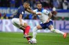 France's Kylian Mbappe, left, and England's Kyle Walker complete for the ball during the World Cup quarterfinal soccer match between England and France, at the Al Bayt Stadium in Al Khor, Qatar, Saturday, Dec. 10, 2022. (AP Photo/Natacha Pisarenko)
