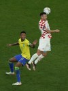 Croatia's Ivan Perisic, right, goes for a header over Brazil's Eder Militao during the World Cup quarterfinal soccer match between Croatia and Brazil, at the Education City Stadium in Al Rayyan, Qatar, Friday, Dec. 9, 2022. (AP Photo/Alessandra Tarantino)