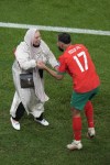Morocco's Sofiane Boufal, right, celebrates with his mother after his team's win in the World Cup quarterfinal soccer match between Morocco and Portugal, at Al Thumama Stadium in Doha, Qatar, Saturday, Dec. 10, 2022. (AP Photo/Luca Bruno)