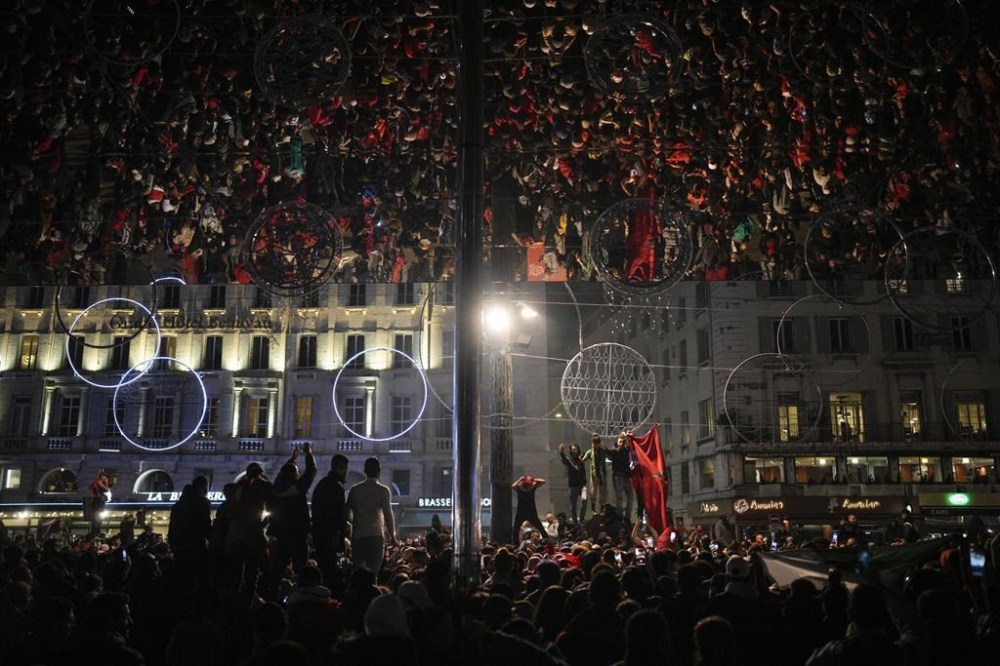 FILE - Morocco fans in Marseille, southern France, celebrate their victory against Spain in the World Cup round of 16 soccer match between Morocco and Spain, Tuesday, Dec. 6, 2022. Morocco and its former colonizer France are facing off in the World Cup semifinal Wednesday, Dec. 14, 2022 in a historic match that has left both nations in the grip of excitement and anticipation — and fear of possible unrest. (AP Photo/Daniel Cole, File)