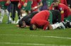Morocco players kneel down on the pitch at the end of the World Cup semifinal soccer match between France and Morocco at the Al Bayt Stadium in Al Khor, Qatar, Wednesday, Dec. 14, 2022. France won 2-0. (AP Photo/Christophe Ena)
