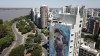 A mural of soccer player Lionel Messi covers a building near the Parana River in Rosario, Argentina, Wednesday, Dec. 14, 2022. (AP Photo/Rodrigo Abd)