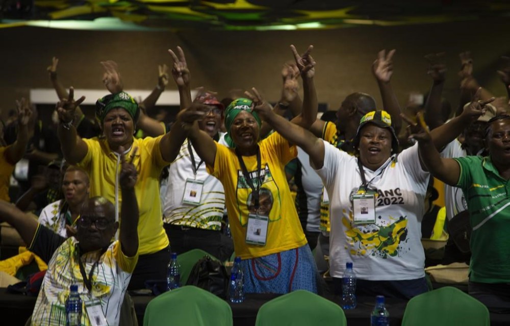 African National Congress delegates cheer as they wait for the delayed start of the ANC national conference in Johannesburg, South Africa, Friday Dec. 16, 2022. The conference will elect the party's leadership and adopt key policies for governing the country. President Cyril Ramaphosa is seeking re-election as the party's leader at the national conference which is held every five years and is the ANC's highest decision-making body. (AP Photo/Denis Farrell)