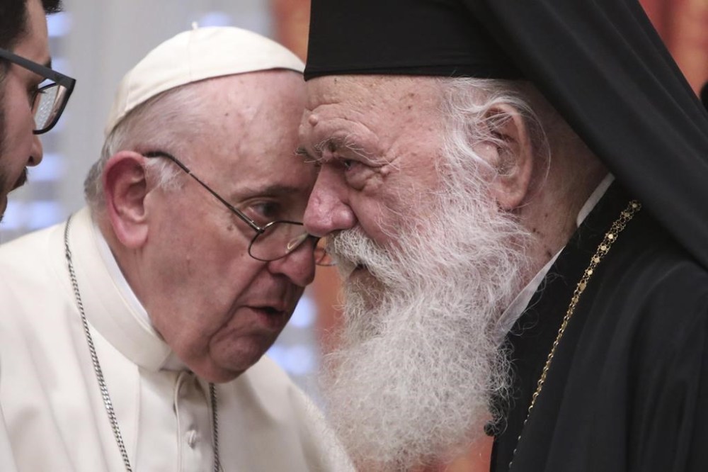FILE - Pope Francis meets Archbishop of Athens and leader of Greece's Orthodox Church, Ieronymos II at the Orthodox archbishopric in Athens, Greece, on Dec. 4, 2021. Pope Francis has decided to send back to Greece the three fragments of Parthenon Sculptures that the Vatican Museums have held for centuries, the Vatican announced Friday, Dec. 16, 2022. The Vatican termed the gesture a “donation” from the pope to His Beatitude Ieronymos II, the Orthodox Christian archbishop of Athens and all Greece, “as a concrete sign of his sincere desire to follow in the ecumenical path of truth.” (George Vitsaras/Pool Photo via AP)
