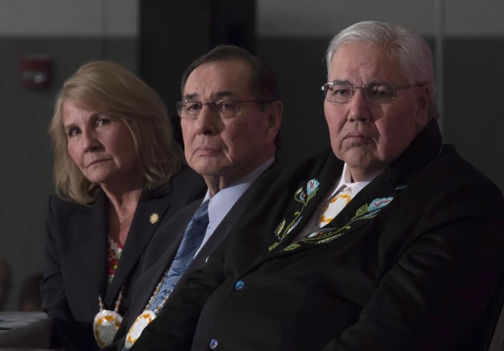 Commissioner Justice Murray Sinclair, Commissioner Chief Wilton Littlechild and Commissioner Marie Wilson (right to left) listen to a speaker as the final report of the Truth and Reconciliation commission is released, Tuesday, Dec. 15, 2015 in Ottawa. Seven years later, an Indigenous-led think tank says progress is moving at a “glacial pace.”THE CANADIAN PRESS/Adrian Wyld
