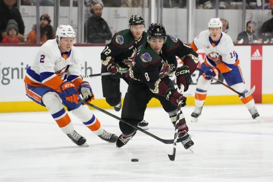 Arizona Coyotes centre Nick Schmaltz (8) carries the puck past New York Islanders defenceman Robin Salo (2) in a  December game. (Rick Scuteri / The Associated Press files)