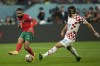 Morocco's Sofiane Boufal, left, is challenged by Croatia's Josko Gvardiol during the World Cup third-place playoff soccer match between Croatia and Morocco at Khalifa International Stadium in Doha, Qatar, Saturday, Dec. 17, 2022. (AP Photo/Francisco Seco)