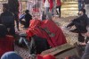 Moroccans draped in the country flag to shelter from rain react as they watch the World Cup semifinal soccer match between France and Morocco played in Qatar, at a public viewing place in Rabat, Morocco, Wednesday, Dec. 14, 2022. (AP Photo/Sonia Moussaid)