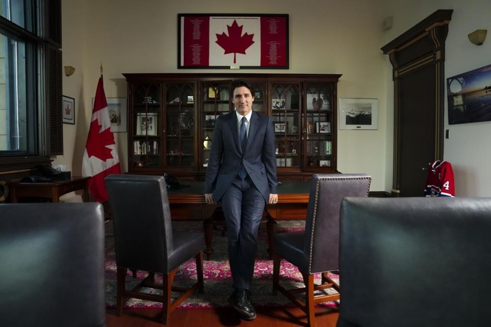 Prime Minister Justin Trudeau poses in his office in Ottawa on Monday, Dec. 12, 2022. Trudeau is asking Canadians to remind themselves how fortunate they are