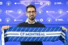 The new head coach of CF Montreal Hernan Losada holds up a CF Montreal scarf following a news conference in Montreal, Thursday, December 22, 2022. The Major League Soccer club announced Wednesday that former D.C. United head coach Hernan Losada will take over from Wilfried Nancy on the sidelines for the 2023 season. THE CANADIAN PRESS/Graham Hughes