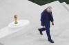 France's head coach Didier Deschamps passes the World Cup trophy after losing the World Cup final soccer match against Argentina at the Lusail Stadium in Lusail, Qatar, Sunday, Dec. 18, 2022. (AP Photo/Thanassis Stavrakis)