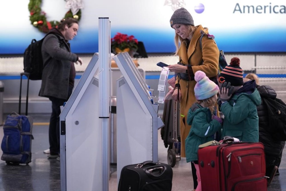 Travelers check in at the American Airlines self ticket counters at O'Hare International Airport in Chicago, Thursday, Dec. 22, 2022. (AP Photo/Nam Y. Huh)