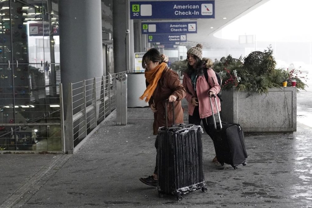 Travelers arrive at Terminal 3 at O'Hare International Airport in Chicago, Thursday, Dec. 22, 2022. (AP Photo/Nam Y. Huh)