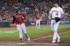 Arizona Diamondbacks' Daulton Varsho (12) scores next to Houston Astros starting pitcher Justin Verlander (35) after a pitch got past catcher Martin Maldonado during the first inning of a baseball game Wednesday, Sept. 28, 2022, in Houston. THE CANADIAN PRESS/AP-Michael Wyke