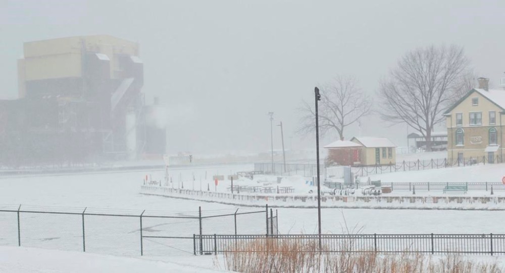 The lake front is almost invisible due to the high winds blowing snow across the frozen mouth of Trail Creek in La Porte County, Ind., on Saturday, Dec. 24, 2022. (Donavan Barrier/La Porte County Herald-Dispatch via AP)