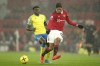 Manchester United's Raphael Varane, right, kicks the ball ahead of Nottingham Forest's Taiwo Awoniyi during the English Premier League soccer match between Manchester United and Nottingham Forest at Old Trafford in Manchester, England, Tuesday, Dec. 27, 2022. (AP Photo/Dave Thompson)