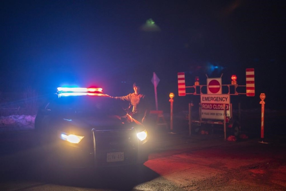 Members of the Ontario Provincial Police close off a section of road near Hagersville, Ont., where an OPP officer was shot and killed on Tuesday, December 27, 2022. THE CANADIAN PRESS/Nick Iwanyshyn