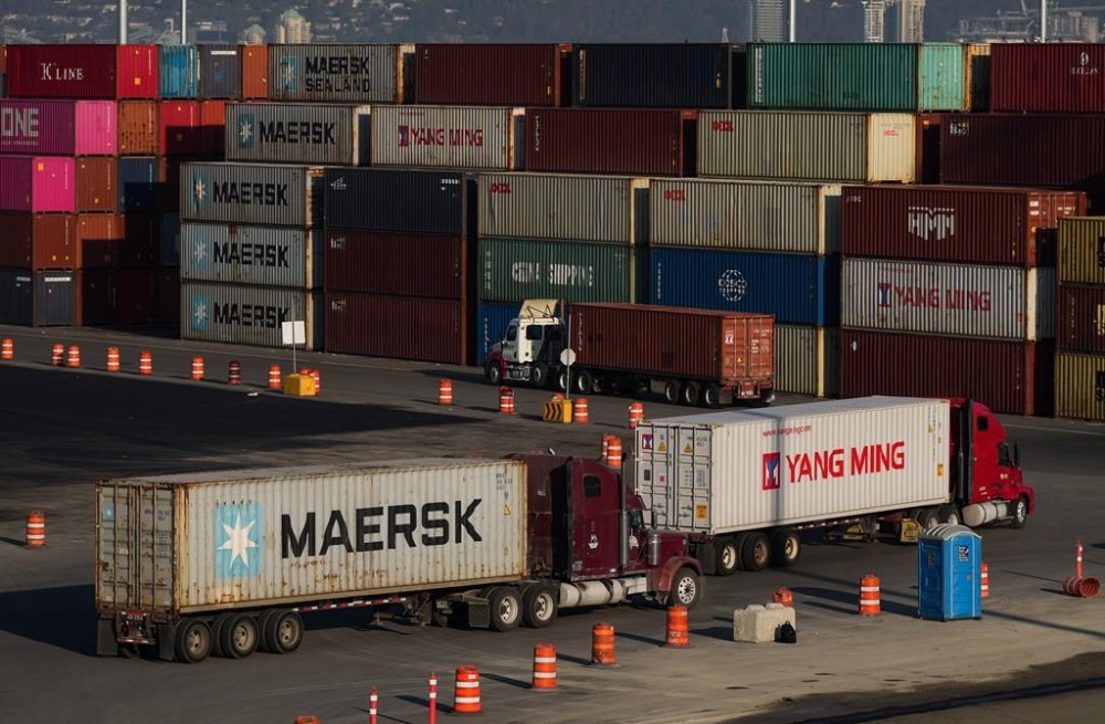 Trucks carrying cargo containers arrive at the Port of Vancouver Centerm container terminal, in Vancouver, on Friday, Oct. 14, 2022. THE CANADIAN PRESS/Darryl Dyck