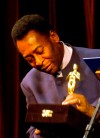 FILE - Brazilian soccer legend Pelé looks at a statue given by the Rio de Janeiro Gov. Rosinha Matheus, at the Municipal Theater in Rio de Janeiro, Monday, June 21, 2004. The recognition was given during the premier of the movie 