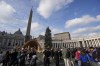 People pause in front of St' Peter's Basilica at The Vatican, Saturday, Dec. 31, 2022. Pope Emeritus Benedict XVI, the German theologian who will be remembered as the first pope in 600 years to resign, has died, the Vatican announced Saturday. He was 95. (AP Photo/Andrew Medichini)