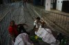 Soccer fans sleep outside the Vila Belmiro stadium waiting for the doors to open for the funeral of the late Brazilian soccer star Pele, in Santos, Brazil Monday, Jan. 2, 2023. (AP Photo/Matias Delacroix)