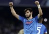 FILE - Napoli's Khvicha Kvaratskhelia celebrates scoring their side's third goal of the game during the group A Champions League soccer match between Napoli and Ajax at the Diego Armando Maradona stadium in Naples, Italy, Oct. 12, 2022. When the Italian league resumes Wednesday Jan. 4, 2022 with a full slate of 10 games and Napoli visiting Inter Milan at the San Siro, the unbeaten Napoli are likely going to need another big contribution from Kvaratskhelia to kick off a potentially decisive five-game stretch that also includes matches against Juventus and Roma, plus a regional derby with Salernitana. (Alessandro Garofalo/LaPresse via AP, File)