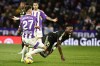 Real Madrid's Vinicius Junior, right falls during a Spanish La Liga soccer match between Valladolid and Real Madrid at the Jose Zorrilla stadium in Valladolid, Spain, Friday, Dec. 30, 2022. (AP Photo/Pablo Garcia)