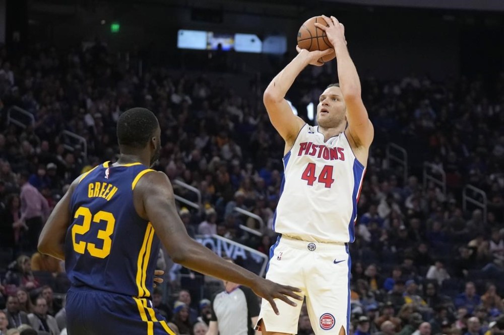 Detroit Pistons forward Bojan Bogdanovic (44) shoots against Golden State Warriors forward Draymond Green (23) during the second half of an NBA basketball game in San Francisco, Wednesday, Jan. 4, 2023. (AP Photo/Jeff Chiu)