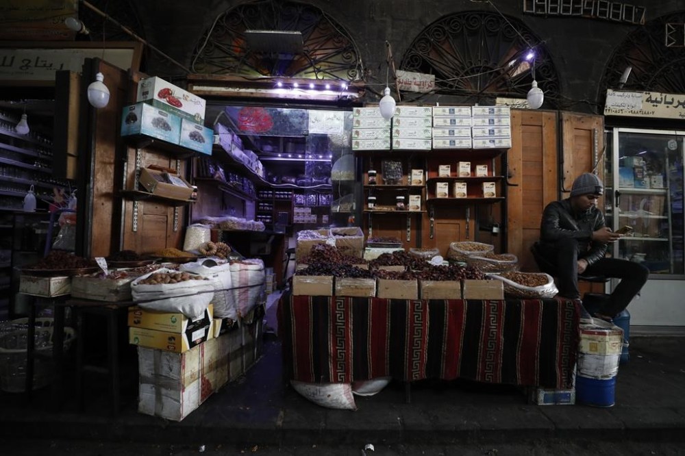 Shopkeeper waits for customers in Damascus, Syria, Sunday, Dec. 15, 2022. Syria's economy has hit its lowest point since the country's civil war began nearly 12 years ago, with severe fuel shortages in both government and rebel-held areas, spiraling inflation and the Syrian currency hitting an all-time low on the black market. (AP Photo/Omar Sanadiki)