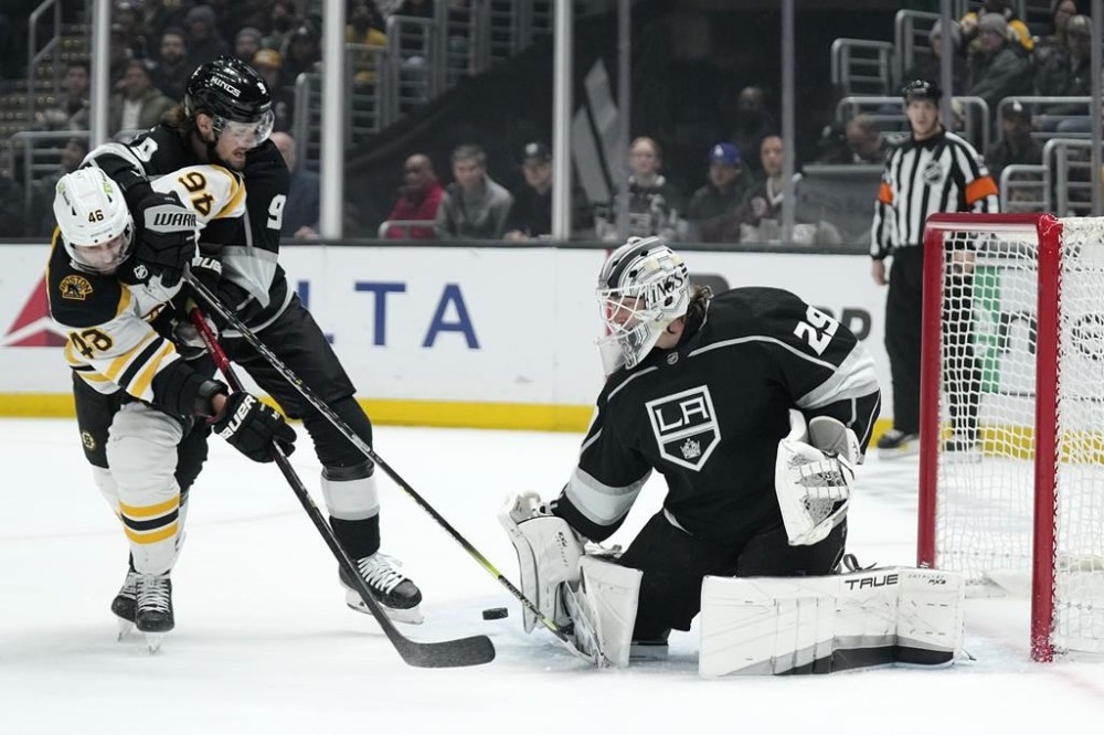 Boston Bruins center David Krejci, left, tries to gat a shot past Los Angeles Kings goaltender Pheonix Copley, right, as right wing Adrian Kempe defends during the first period of an NHL hockey game Thursday, Jan. 5, 2023, in Los Angeles. (AP Photo/Mark J. Terrill)