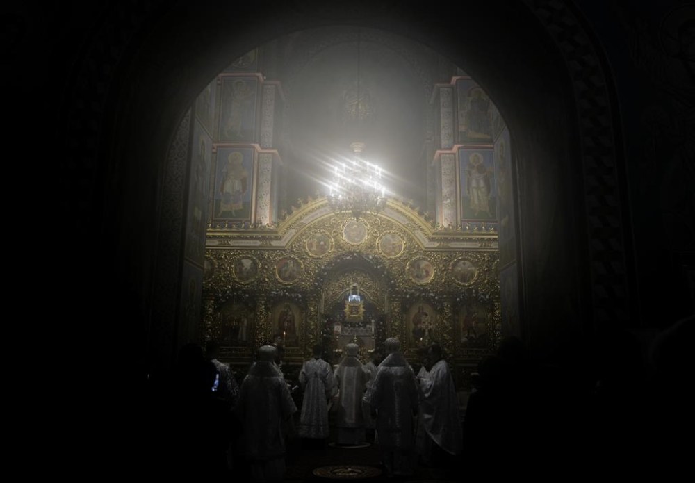 Ukrainian priests holding a service before the start of the Orthodox Chrismas in the St. Michael's Monastery of Kyiv, Ukraine, Friday, Jan. 6, 2023. Russian President Vladimir Putin on Thursday ordered Moscow's armed forces to observe a 36-hour cease-fire in Ukraine this weekend for the Russian Orthodox Christmas holiday, but Ukrainian President Volodymyr Zelenskyy questioned the Kremlin's intentions, accusing the Kremlin of planning the fighting pause