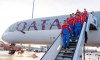 The players of the German Bundesliga team FC Bayern Munich stand on a staircase of an airplane of the airline Qatar Airways at the airport in Munich, Gemany, Friday, Jan. 6, 2023. The Bayern Munich team flies to Qatar on Friday for its winter training camp amid uncertainty over the club’s contentious sponsorship agreement with the Persian Gulf country. (Peter Kneffel/dpa via AP)