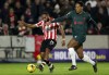 Brentford's Bryan Mbeumo, left, duels for the ball with Liverpool's Virgil van Dijk during the English Premier League soccer match between Brentford and Liverpool at the Gtech Community Stadium in London, Monday, Jan. 2, 2023. (AP Photo/Ian Walton)