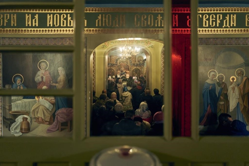 People attend the Christmas service in the Cathedral in Kherson, Ukraine, Saturday, Jan. 7, 2023. (AP Photo/Libkos)