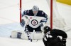 Winnipeg Jets goaltender David Rittich (33) stops a shot by Washington Capitals left wing Sonny Milano (15) during the first period. (AP Photo/Nick Wass)