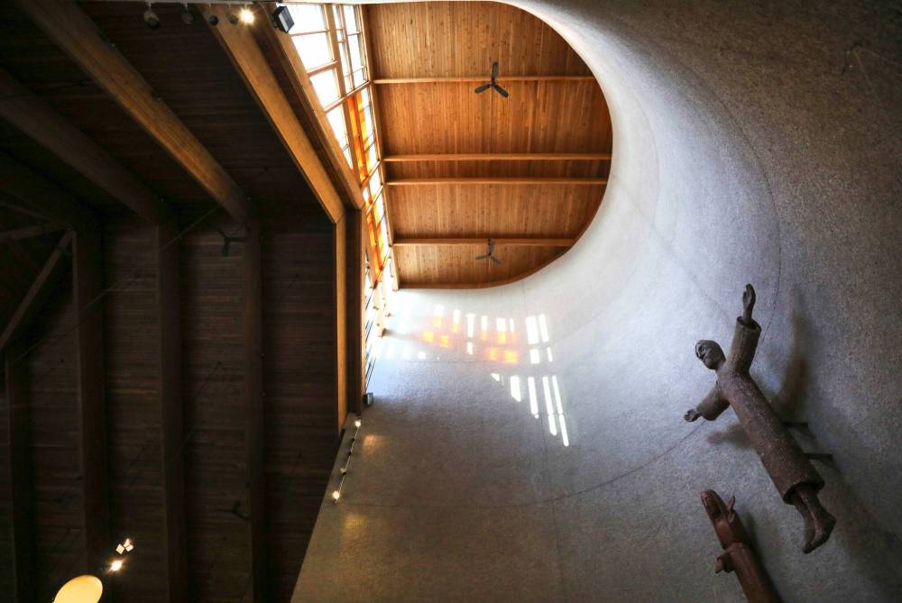RUTH BONNEVILLE / WINNIPEG FREE PRESS
The St. Boniface Cathedral, designed by Etienne Gaboury from 1969 to 1972 A selection of photos of some of the design elements to illustrate Gilmore’s story. Characteristics of the cathedral: warm wood that rises into an angled ceiling that contrasts with a curving stuccoed apse where light flows in from a hidden source. Hipped roof with the interplay of square and circle forms emphasizing the importance of light. Hanging globe lamps that glow with golden light, with much of the illumination in the cathedral coming from the low winter sun shining through expanses of glass near ground level, along the south walls of the nave.This light also passes through the abstracted modernist version of the Stations of Cross — which was created by Gaboury himself — and intensifies the colours of the stained glass. In the narthex of Gaboury’s church is a wooden maquette depicting the earlier 1906 cathedral. See Alison Gilmore’s story. Dec 1st, 2022